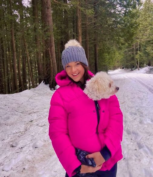 Phoebe Adele Gates with her dog in the snow