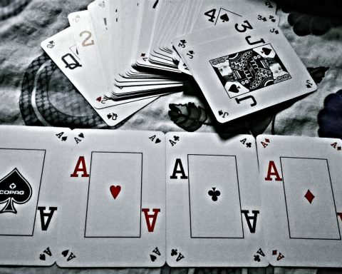 grayscale photography of playing cards placed on cloth